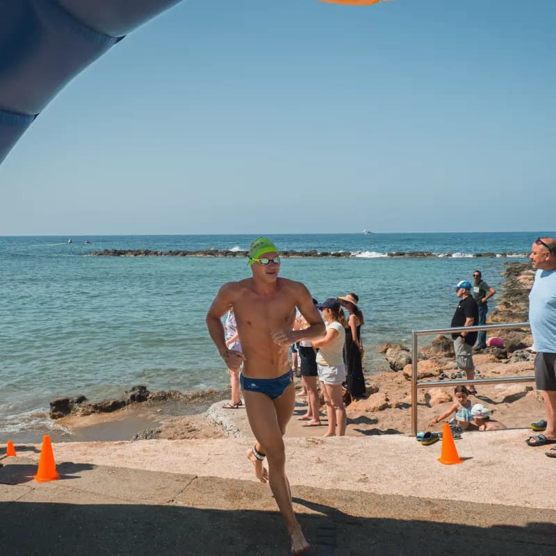 Swimmer running out of the sea at Cyprus Swim Series